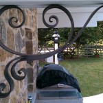 Forged and acid blackened stainless steel decorative support